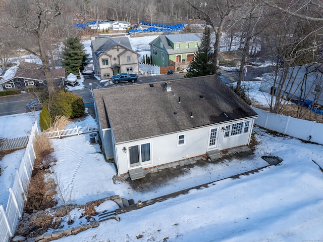 snowy aerial view with a residential view