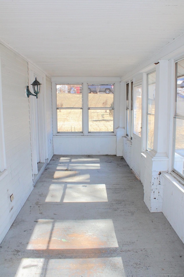 unfurnished sunroom featuring plenty of natural light