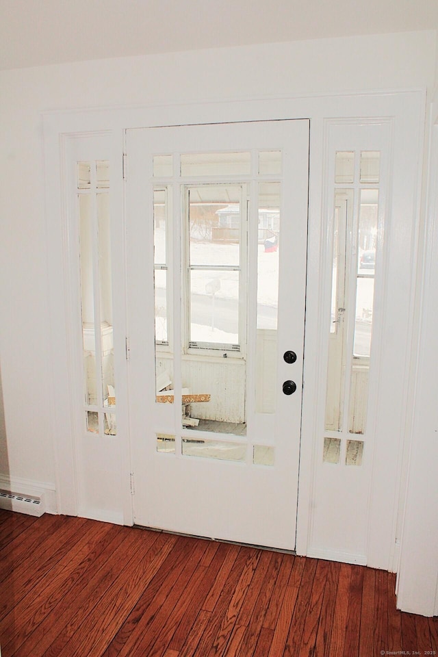 foyer featuring dark wood-style floors and visible vents