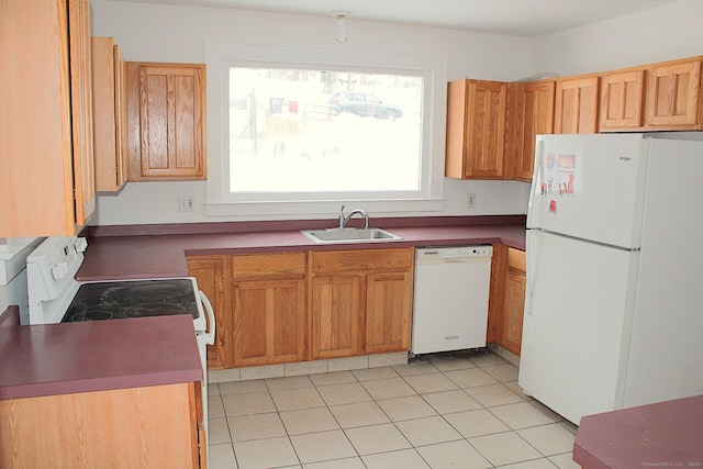 kitchen featuring white appliances, a sink, and light tile patterned floors