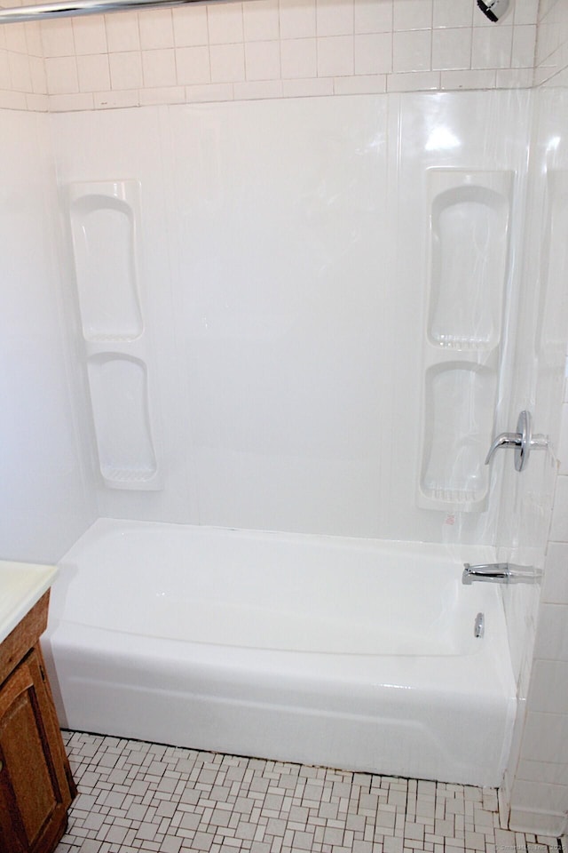 bathroom with bathing tub / shower combination, vanity, and tile patterned floors