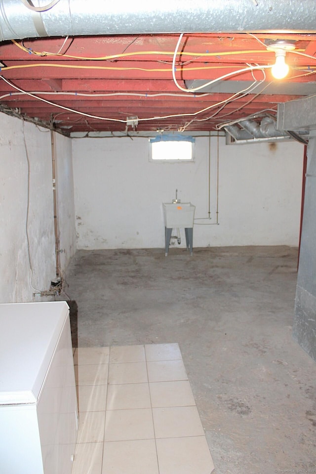 basement with fridge and a sink