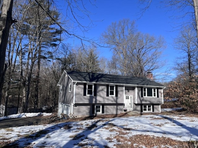 raised ranch featuring a chimney