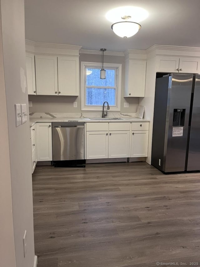 kitchen with a sink, appliances with stainless steel finishes, and white cabinets