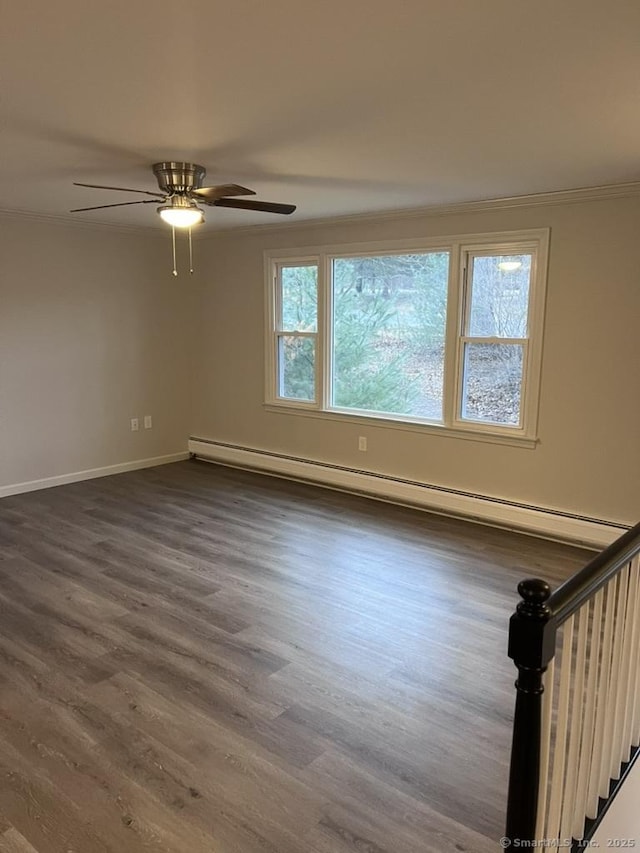 empty room with a ceiling fan, a baseboard heating unit, dark wood-style floors, baseboards, and stairs