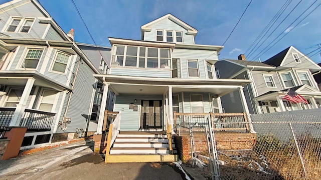 view of front facade featuring fence and a porch