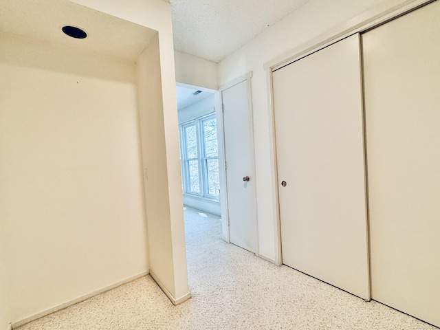 corridor with light speckled floor