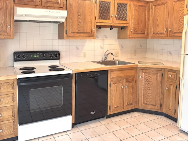 kitchen featuring dishwasher, electric range oven, range hood, light countertops, and a sink