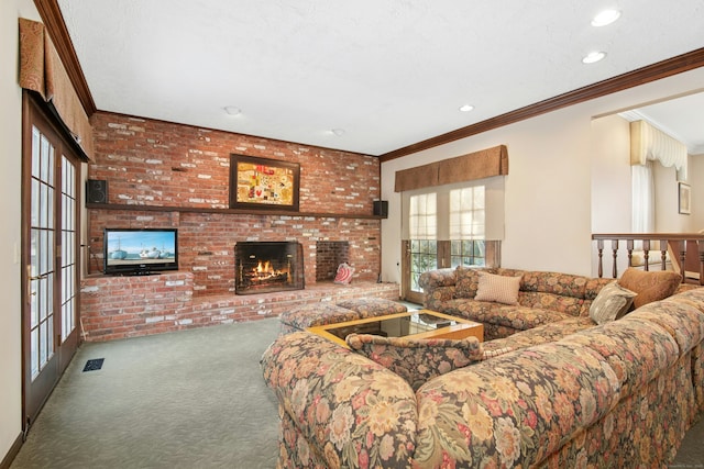 living area with carpet floors, crown molding, recessed lighting, visible vents, and a brick fireplace