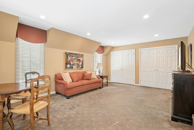 carpeted living area featuring baseboards, vaulted ceiling, and recessed lighting