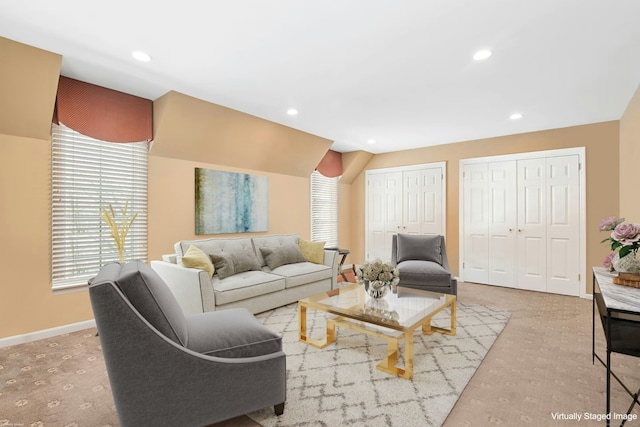 carpeted living area with baseboards, lofted ceiling, and recessed lighting