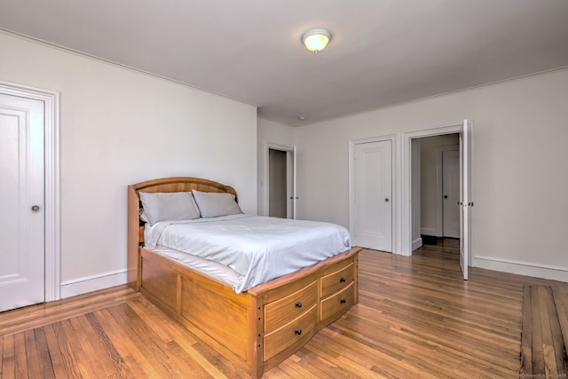 bedroom featuring baseboards and hardwood / wood-style floors