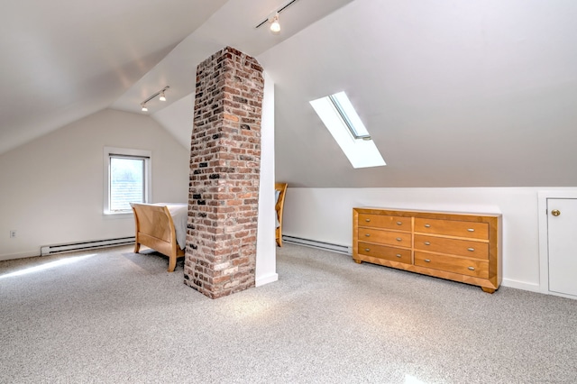 additional living space with a baseboard heating unit, carpet flooring, and lofted ceiling with skylight