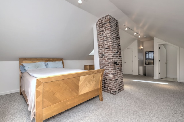 carpeted bedroom featuring baseboards, vaulted ceiling, and track lighting