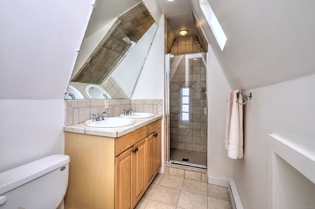 full bathroom with a shower stall, decorative backsplash, baseboard heating, and a sink