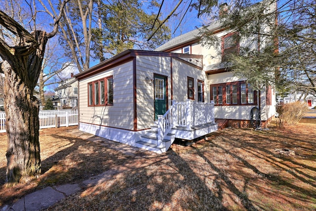 rear view of property featuring fence