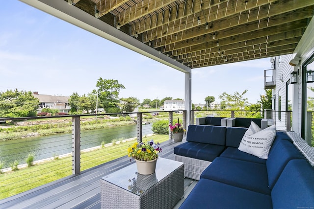 balcony with outdoor lounge area and a water view