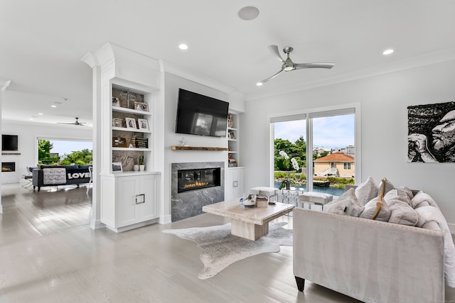 living room featuring recessed lighting, a premium fireplace, a wealth of natural light, and ceiling fan