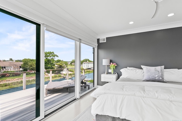 bedroom featuring recessed lighting, access to exterior, visible vents, and a water view