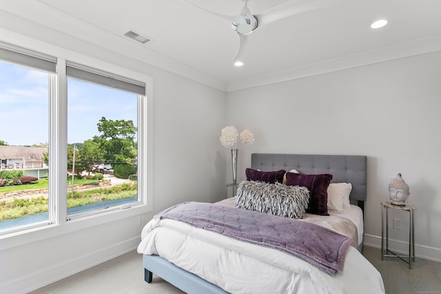 bedroom featuring visible vents, baseboards, and multiple windows