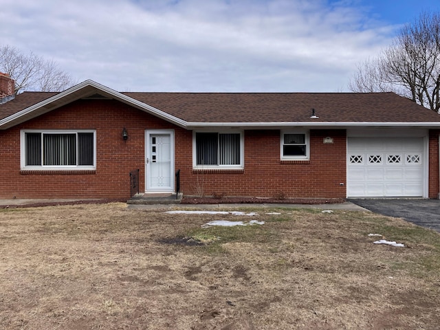 single story home featuring brick siding, aphalt driveway, a garage, and roof with shingles