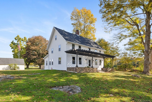 exterior space with a chimney, a pergola, and a yard