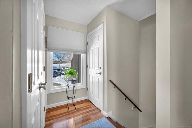 entryway with light wood-style flooring and baseboards