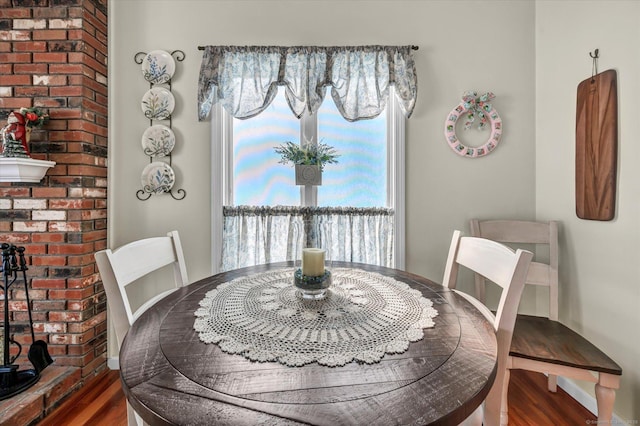 dining space with wood finished floors