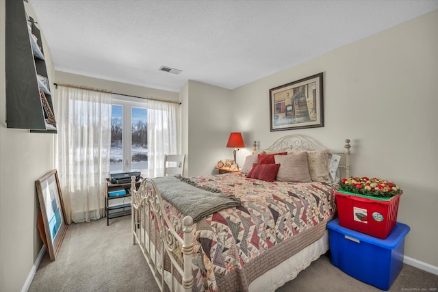 bedroom featuring carpet floors, baseboards, visible vents, and a textured ceiling