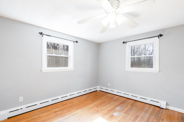 unfurnished room featuring a ceiling fan, a baseboard radiator, and wood finished floors