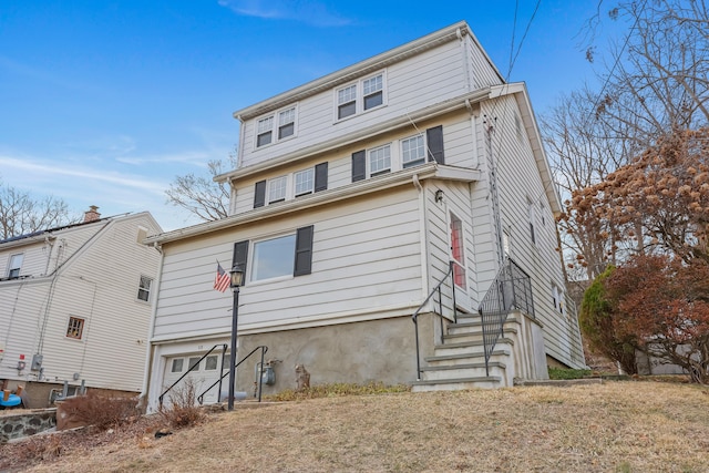 back of property with an attached garage