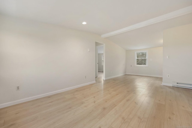 spare room featuring light wood-style floors, a baseboard heating unit, vaulted ceiling with beams, and baseboards