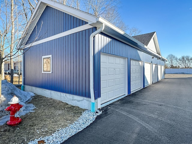 view of side of property with community garages