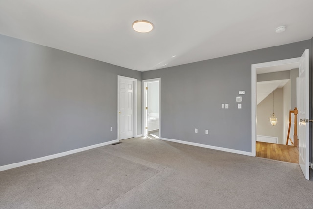 empty room featuring baseboards and carpet flooring