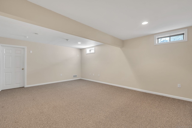 below grade area with recessed lighting, visible vents, a healthy amount of sunlight, carpet flooring, and baseboards