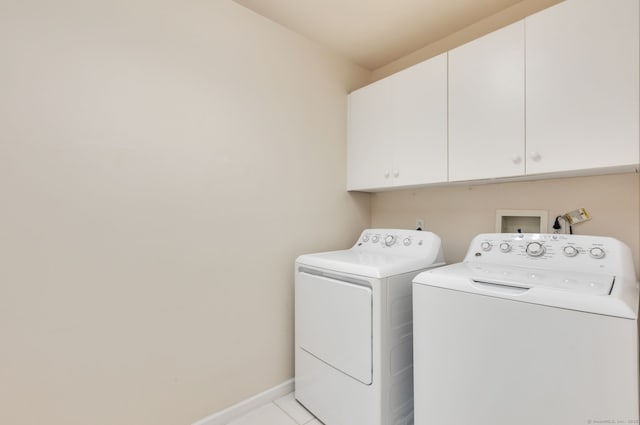 laundry room featuring cabinet space, independent washer and dryer, baseboards, and light tile patterned floors