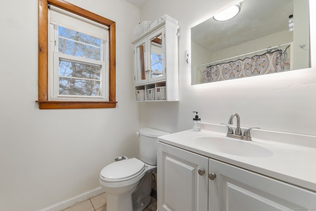 bathroom featuring baseboards, a shower with shower curtain, toilet, tile patterned floors, and vanity