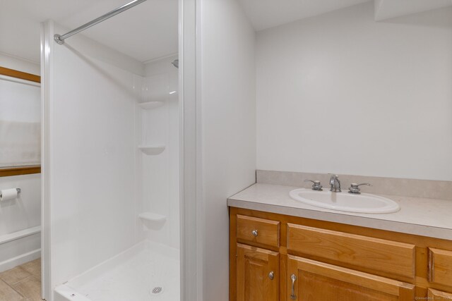 bathroom with walk in shower and vanity