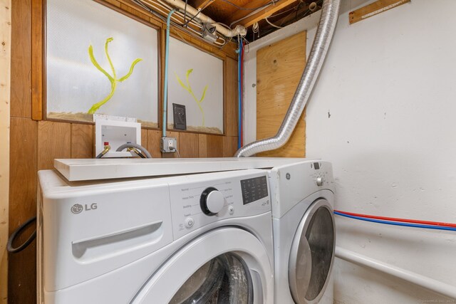 clothes washing area with laundry area and washing machine and clothes dryer