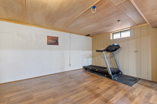 exercise area featuring wood ceiling and wood finished floors