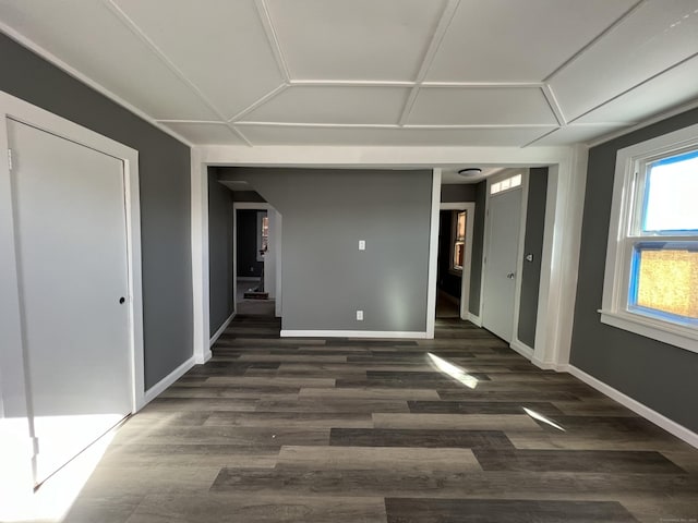 empty room with dark wood-style floors and baseboards