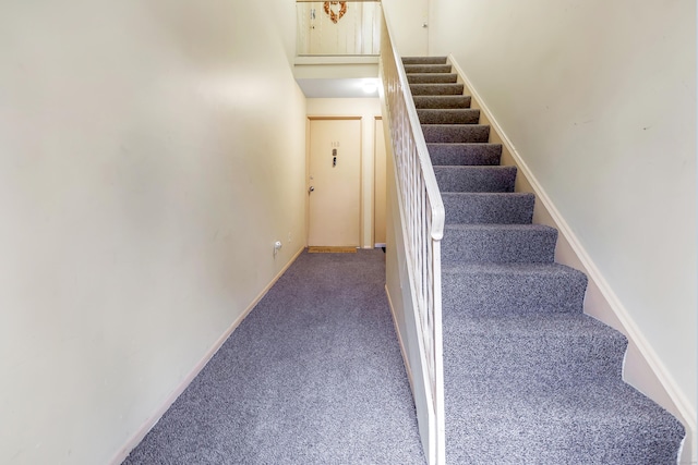 stairway with carpet flooring and baseboards