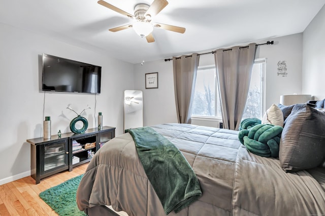 bedroom featuring light wood-type flooring, ceiling fan, and baseboards