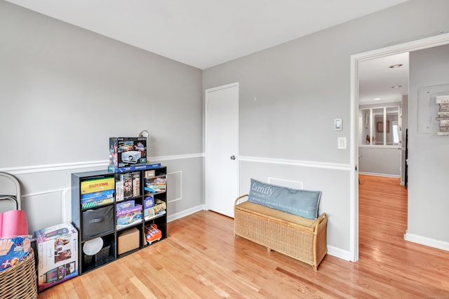 living area featuring baseboards and wood finished floors