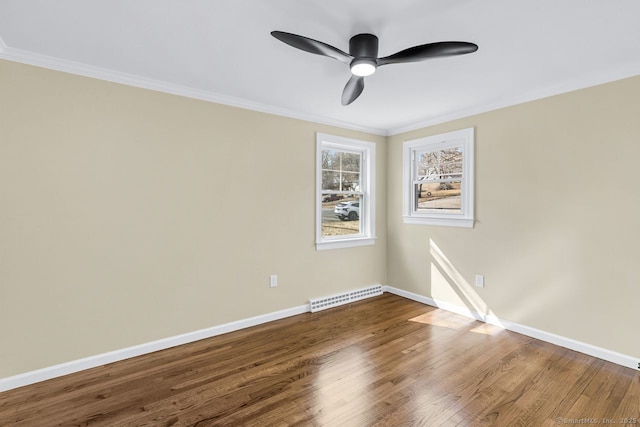 unfurnished room featuring visible vents, crown molding, baseboards, and wood finished floors