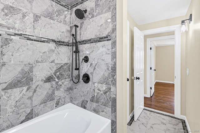 bathroom featuring marble finish floor and baseboards