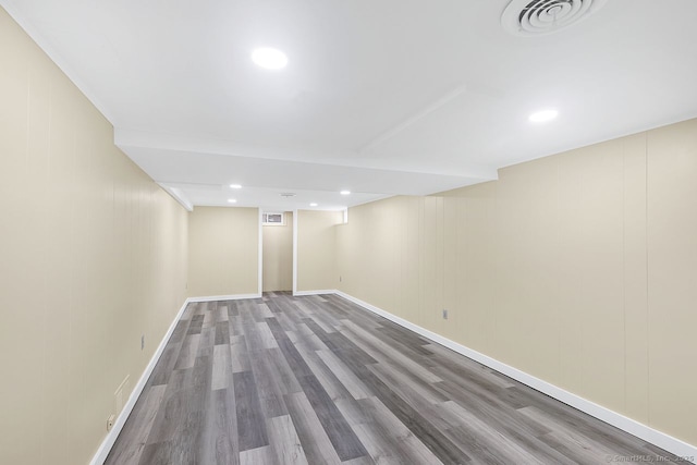 finished below grade area featuring visible vents, wood finished floors, and recessed lighting