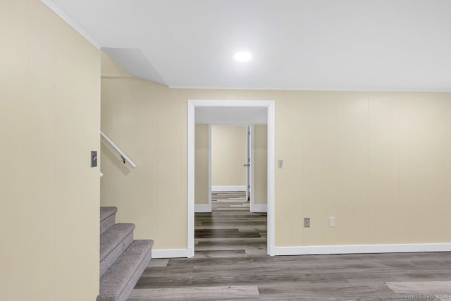 staircase featuring baseboards and wood finished floors