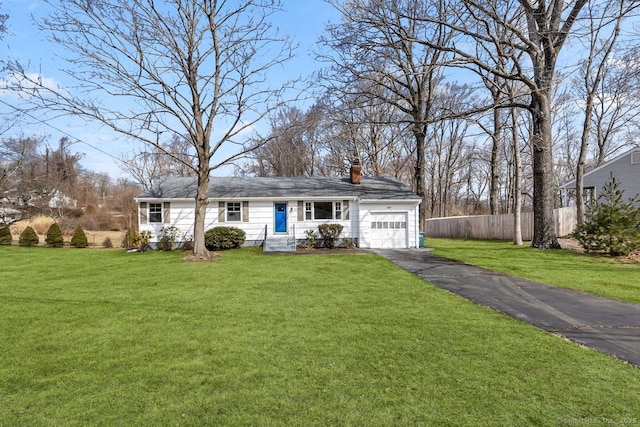 ranch-style home featuring aphalt driveway, an attached garage, fence, a front lawn, and a chimney