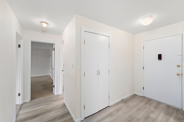 entrance foyer with light wood-style flooring and baseboards